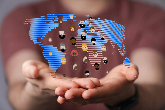 Concept of global connection, communication, and diversity. Diverse faces and a world map in hand represent unity and wo