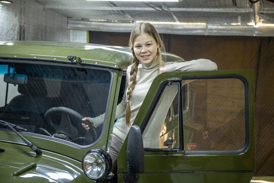 Young beautiful teen girl driving an off-road vehicles