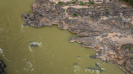 Khone Phapheng Waterfall, the largest waterfall on the Mekong River, features powerful multi-tiered cascades rushing over massive rock formations, creating one of the most dramatic natural © Narong Niemhom