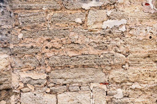 Weathered brick wall with limestone and coquina stone masonry texture background for construction use