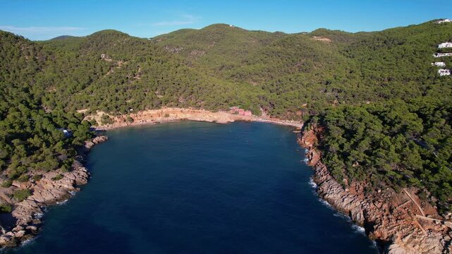 Aerial images of cala Saladeta, on the island of Ibiza during a sunny summer day, Balearic Islands, cala salada, 4k 30fps