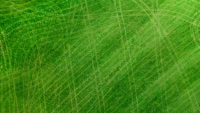 Professional lawn care cross stripes, lush green turf aerial
