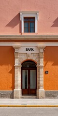 Naklejka premium Bank facade with orange base stone arch doorway and upper window set in pastel stucco town street