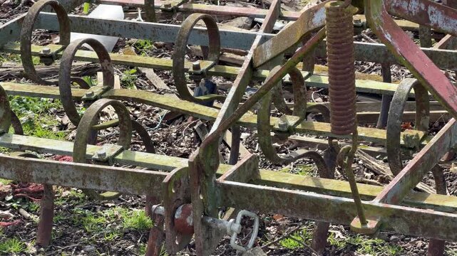 Weathered agricultural equipment with metal tines panning