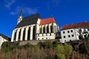 Fototapeta premium Historic Cesky Krumlov Castle Complex and St Vitus Church Reflected in Vltava River