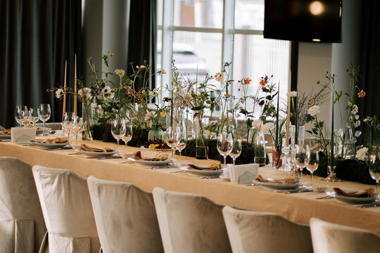 Elegant dining setup features flowers and candles at a modern venue
