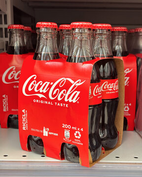 on the store shelf, a pack of 4 glass bottles of Coca-Cola Original Taste, 200 ml each. Udine, Italy, February 9, 2026