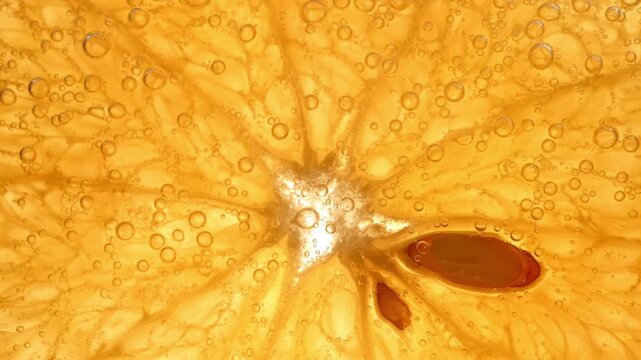 Extreme macro of orange slice with bubbles in sparkling liquid. Bright citrus texture with juicy pulp and rising bubbles, perfect for beverage ads, fresh summer concepts abstract food backgrounds.