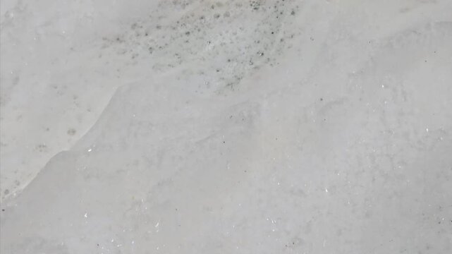 Close-up of Acidic Chemical Foam Reacting on Industrial Steel Surface