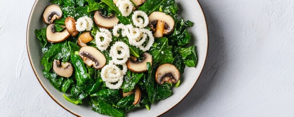 Vibrant overhead view SautÃ©ed kale and mushrooms with unique crispy white rings in a bowl on a light textured surface. Healthy, fresh, appetizing flat lay., Vegan ,Side Dish