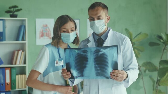 Medical team evaluates, Medical staff work together to interpret radiographs and plan urgent patient care effectively