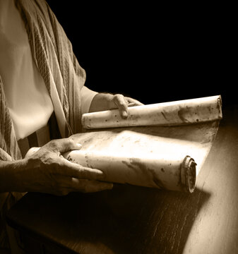 Man's hans holding a scroll