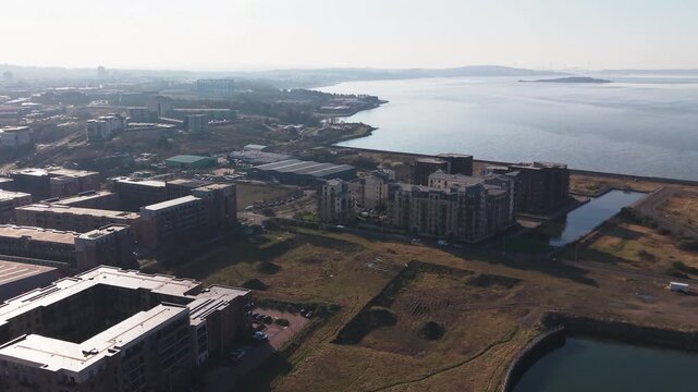 Aerial view of modern apartment buildings and new residential development near Granton Harbour and Firth of Forth in Edinburgh, Scotland