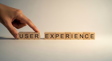 Hand arranging wooden blocks with user experience text