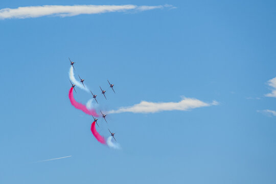 A group of aerobatic jet aircraft flying in perfect formation du