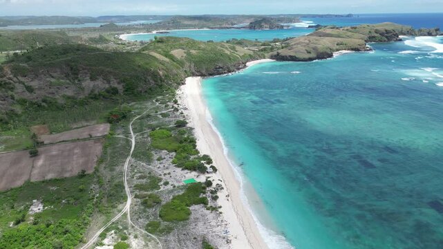 Pertamina Mandalika Circuit by the sea in Lombok, Indonesia. Stunning aerial view of the modern racetrack next to the beautiful tropical ocean and beach. Perfect for motorsport, travel, and tourism.