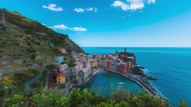 Vernazza, Italy: 4K static timelapse of the historic harbor and Doria tower under a clear blue sky in the afternoon, ideal for travel documentaries.