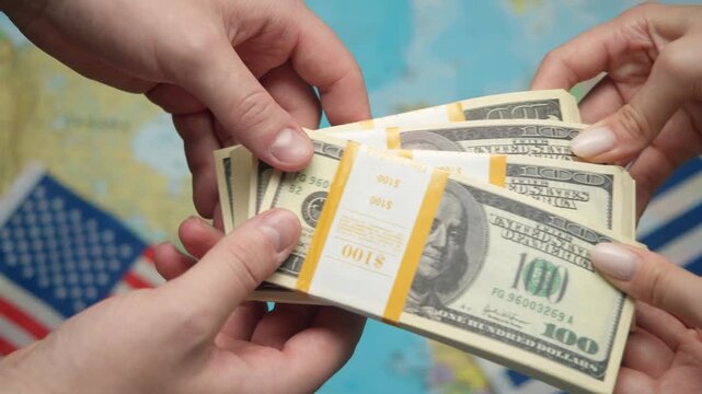 American banker passes stack of dollars to Greek representative against world map with US and Greek flags for financial aid.
