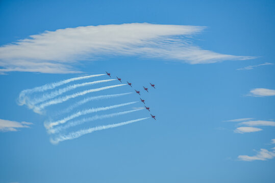 A group of aerobatic jet aircraft flying in perfect formation du
