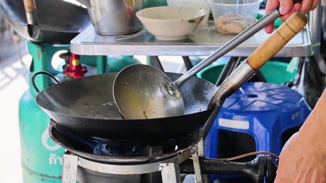 Street Food Stir Fry Noodles Cooking in Wok on Gas Burner Bangkok Thailand