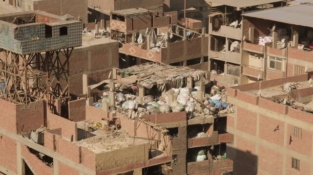 Residential buildings with bales of garbage on lids for recycling at Garbage City in Manshiyat Naser on outskirts of Cairo