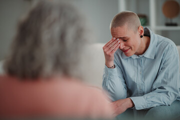 Young woman crying during therapy session with counselor