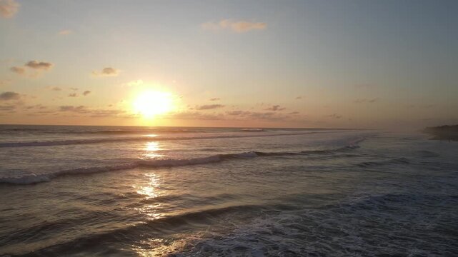 Golden Sunset on Beach with Waves and Sun Reflection