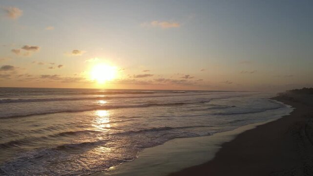 Golden Sunset on Beach with Waves and Sun Reflection
