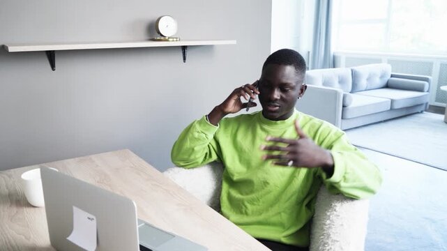 Young happy smiling afroamerican man working with modern laptop, technology and lifestyle young people concept