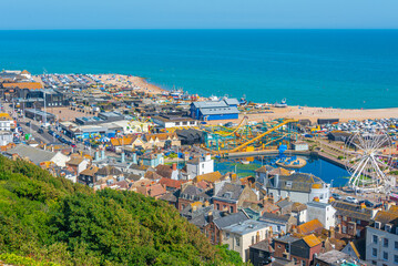 People are enjoying a sunny day on a beach in Hastings, England © dudlajzov