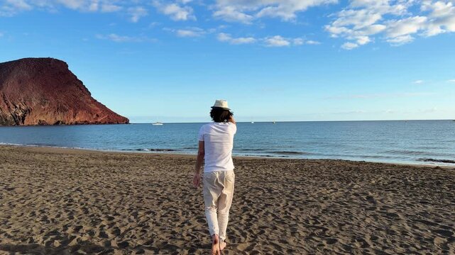 man walking near Atlantic ocean at el Medano Tenerife, Spain