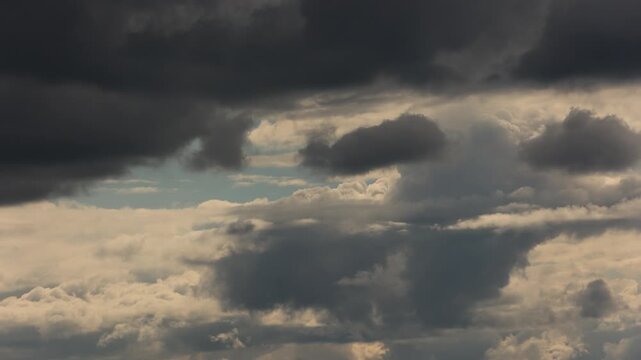 moody dramatic dark clouds timelapse over blue sky