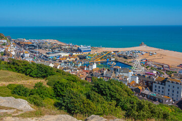 Naklejka premium People are enjoying a sunny day on a beach in Hastings, England