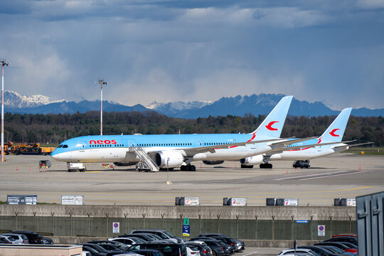 Somma Lombardo, Italy 24 Mar 23: Neos airliner on airport apron with mountains in background