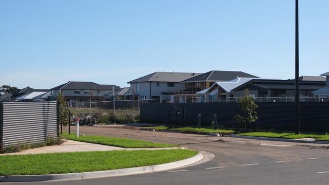 New suburban housing in Truganina, Melbourne, Australia, with modern homes bordering undeveloped land and empty lots. Rapid urban expansion of growing outer suburbs.