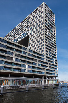 Pontsteiger (&lsquo;ferry pier&rsquo;) is a large residential building (2019), is located at the end of a 200-metre dam that projects into the water of the River IJ. AMSTERDAM, The NETHERLANDS. March 20, 2026.