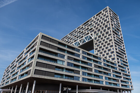 Pontsteiger (&lsquo;ferry pier&rsquo;) is a large residential building (2019), is located at the end of a 200-metre dam that projects into the water of the River IJ. AMSTERDAM, The NETHERLANDS. March 20, 2026.