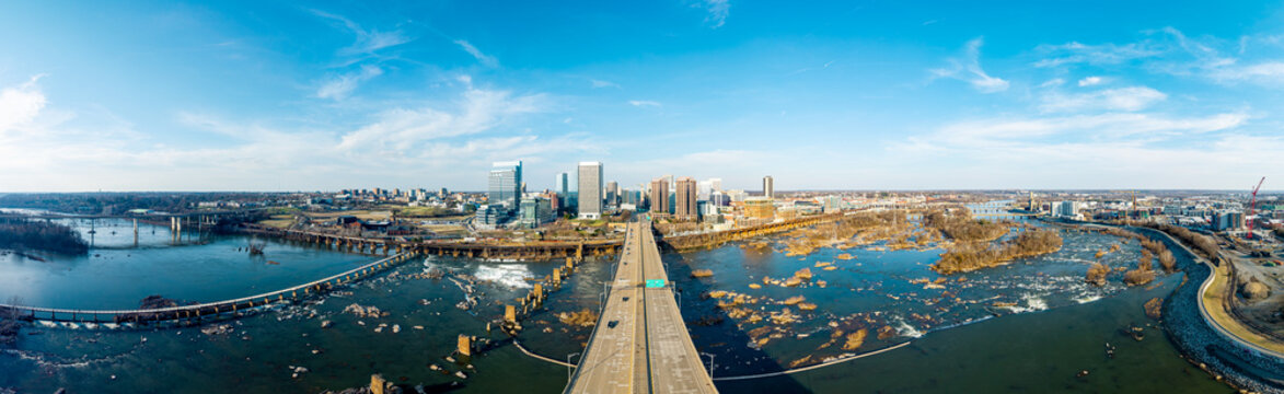 Richmond, Virginia, aerial panorama of the Manchester Bridge spanning the James River with the downtown city skyline in the background.