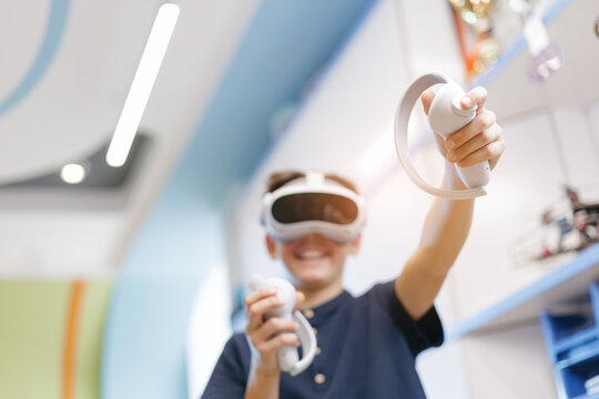 Closeup VR controllers, boy playing with virtual reality in tech lab, Innovative computer education for child
