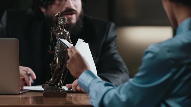 Lawyer advising client on legal matters in office environment. Justice and consultation concept.
