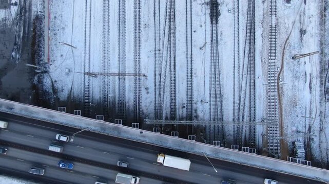 Vertical aerial retreat over snowy rail tracks