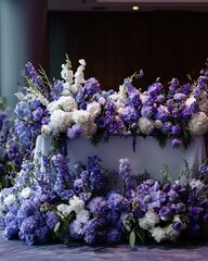 A lavish floral arrangement on a table, bursting with various purple and white flowers. The overall ambiance is of elegance and sophistication