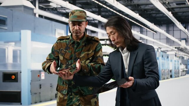 Increasing microchips production, defense gear and microelectronics production factory manager brainstorming with soldier. Helping army with semiconductors, chip war and engineer, camera B