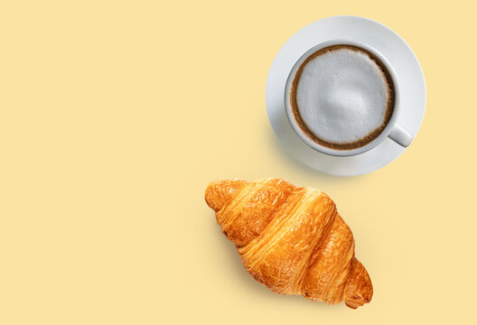 Hot Coffee Latte and Fresh Croissant on Yellow Background Top view