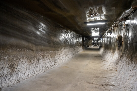 Salt-encrusted corridor with fluorescent lights, Salina Turda