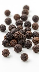 Obraz premium Pile of Black Peppercorns on White Background Close-Up.