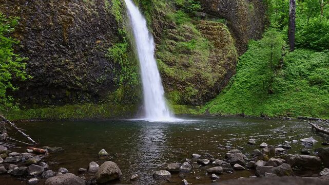 Horsetail Falls dropping down large rock and into pool at bottom, Columbia River Gorge, National Scenic Area, spring adventure and tourism in Oregon
