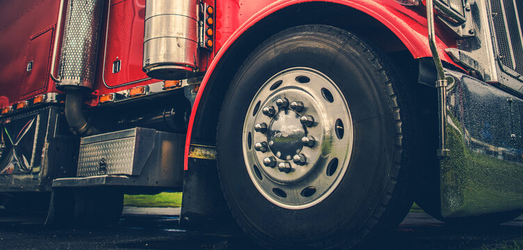 Big Red Truck Parked on Green Grass Near the Road