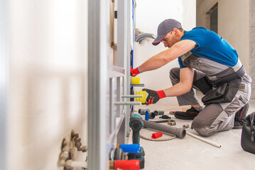 Plumber Works on Pipe Fittings in Indoor Space