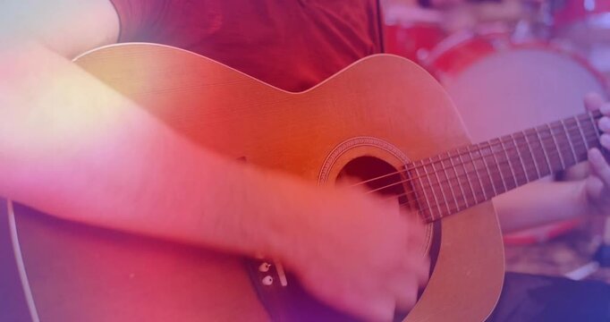 Guitarist strumming as pullback revealing phones adjusting, tracking drummer as flares sweeping